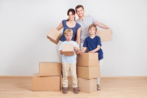 Removal van and moving boxes in a residential Cheam street