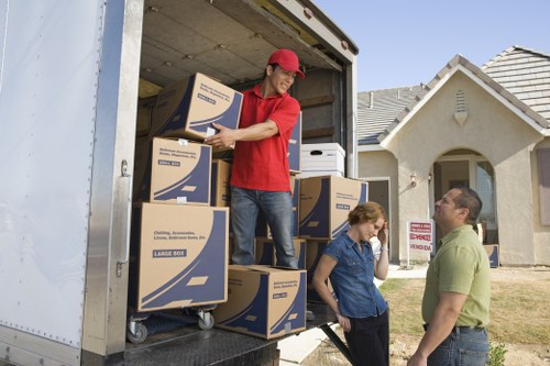 Local moving team handling boxes during a house removal in Cheam