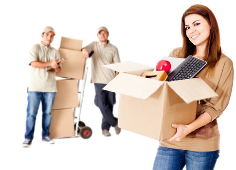 Professional movers carrying furniture in a Cheam residential street